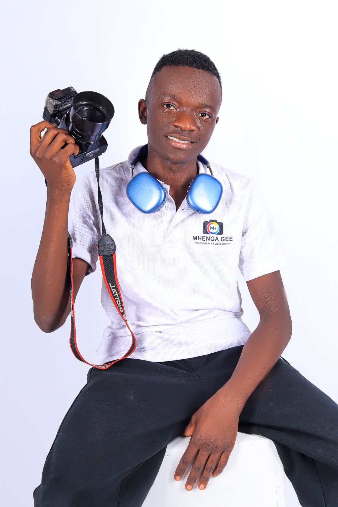 MhengaGee Media creator holding a camera